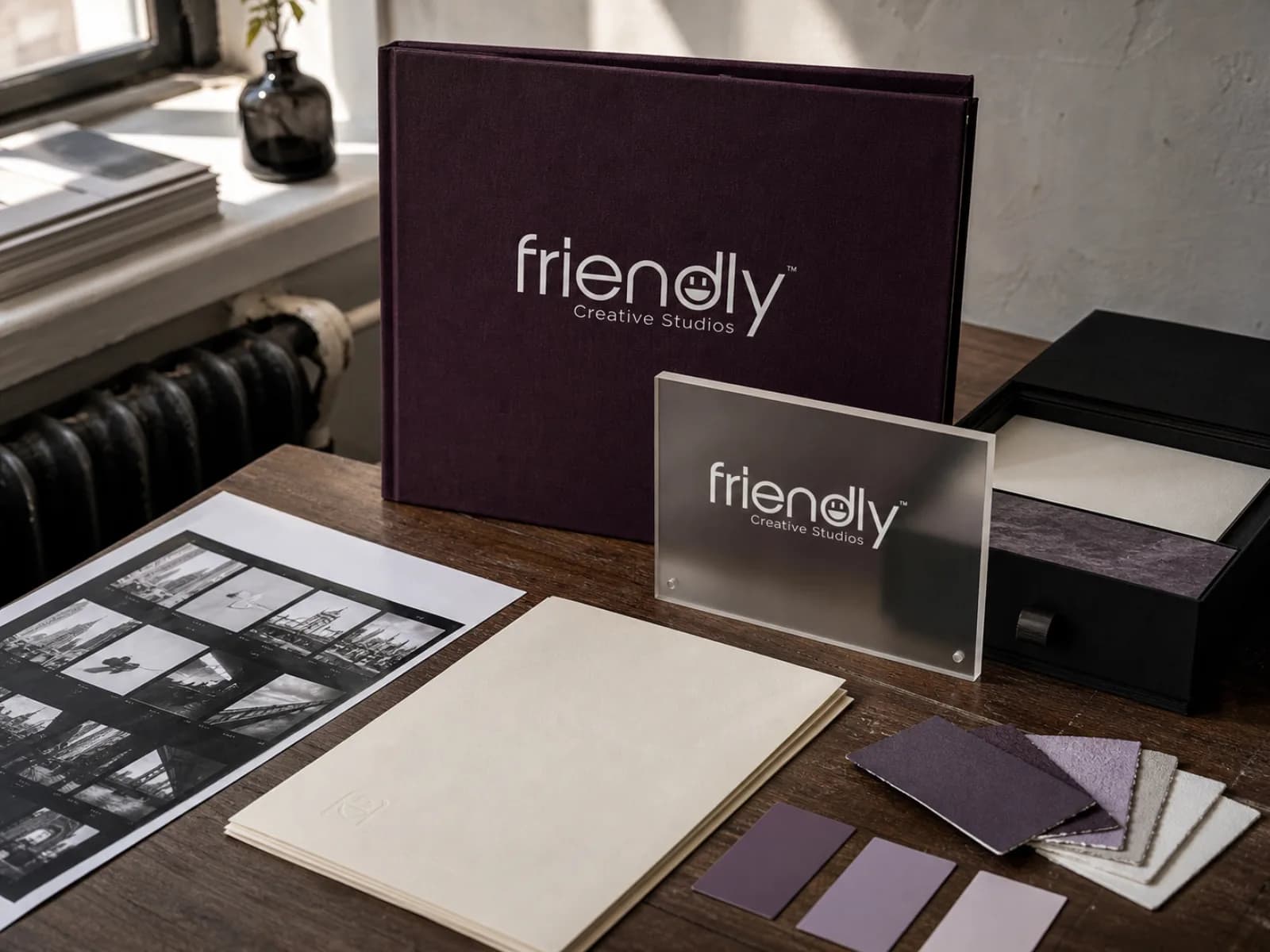 Friendly Creative Studios identity applied to a portfolio and studio sign